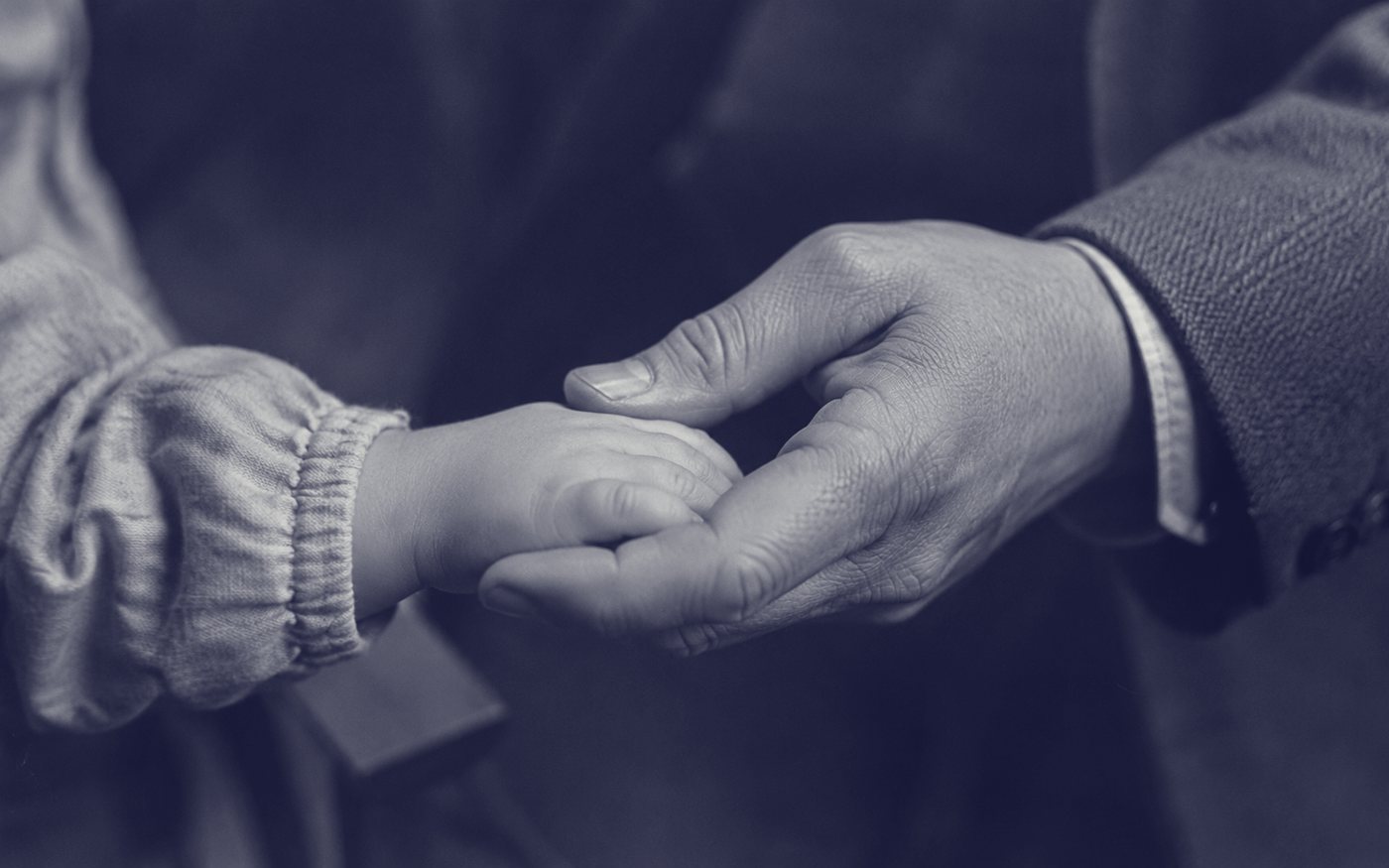 A child's hand held in an adult's hand